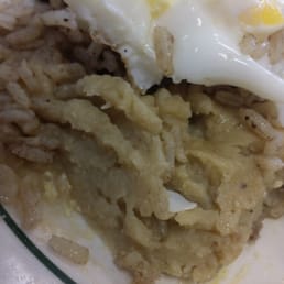 a plate of food with rice and an egg a plate of food with rice and an egg
