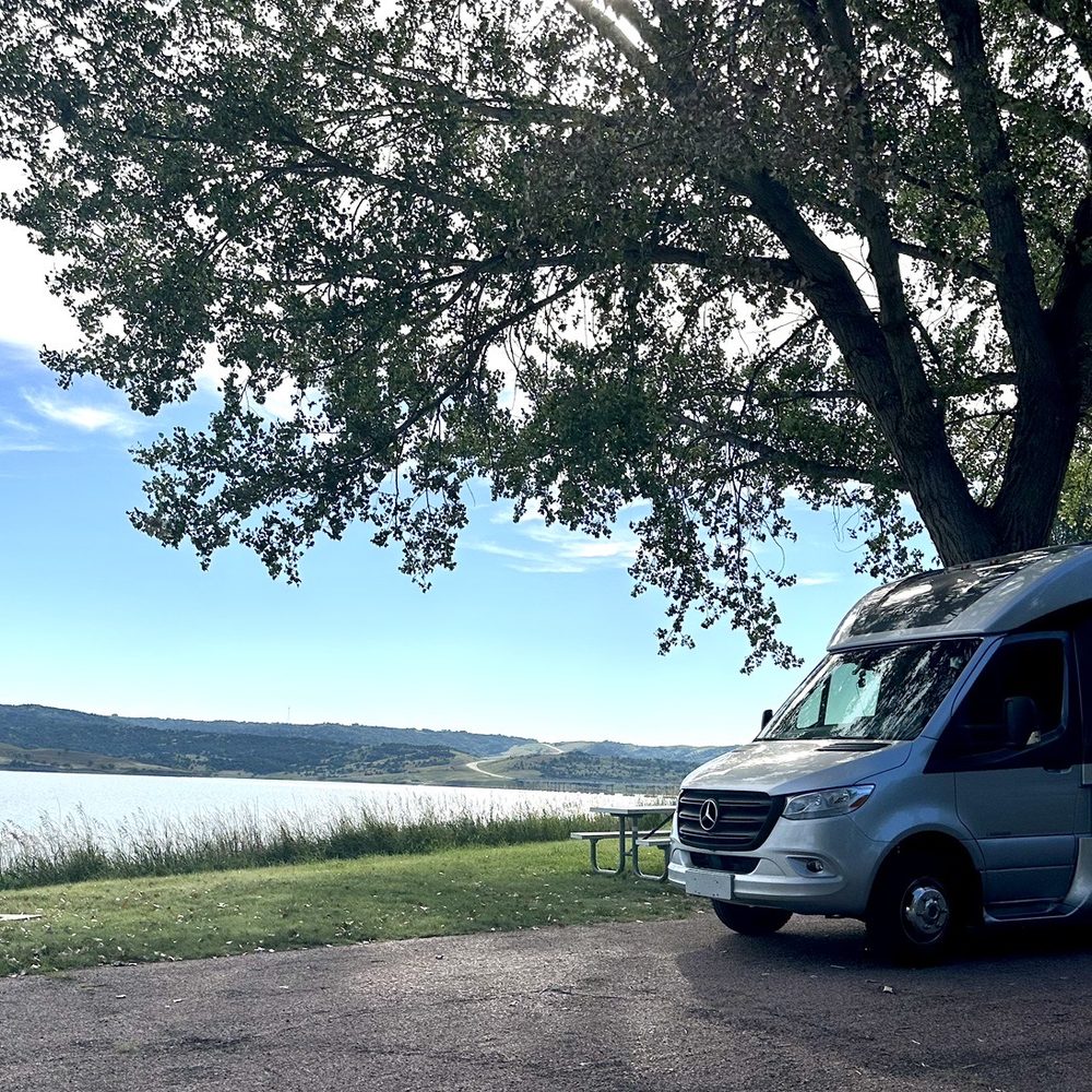 Snake Creek Recreation Area - A Leisure Travel Van Unity at a water side slot at the snake Creek recreation area. - Parks Near Me - Platte, South Dakota