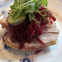 Restaurant PUK - Smørrebrød open-faced sandwich with a slice of rye bread, salted butter, and sliced roasted pork with red cabbage and pickles. - sandwiches, sandwich, food - Dansk Near Me - København, 84