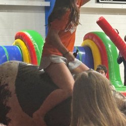 The Bull Guys - My daughter riding the bull.