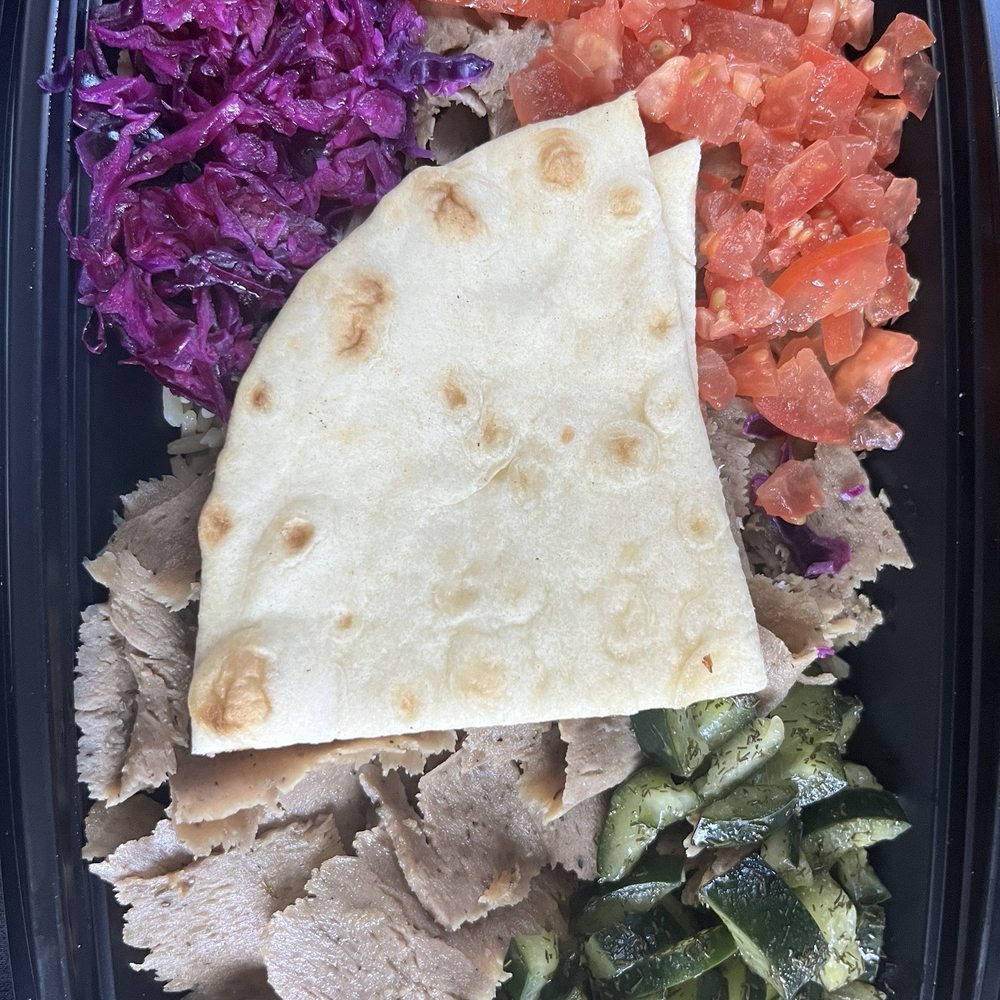 Carved beef and lamb Dill cucumber  Diced tomatoes  Purple cabbage Pita bread