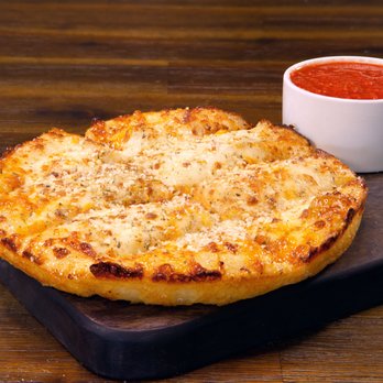 Pizza Patrón - Our fresh made dough is smothered with garlic butter, then sprinkled with our secret Patron Shake & topped with Parmesan and Romano cheeses. - Pizza Near Me - Kyle, Texas Pizza Patrón - Our fresh made dough is smothered with garlic butter, then sprinkled with our secret Patron Shake & topped with Parmesan and Romano cheeses. - Pizza Near Me - Kyle, Texas