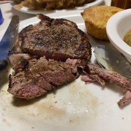 Med rare filet mignon , blooming onion in the back. Med rare filet mignon , blooming onion in the back.