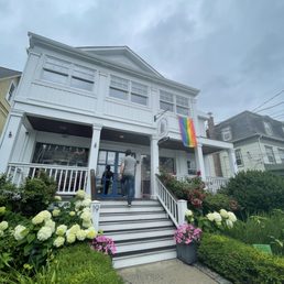 Entrance to the building with summer flowers and rainbow flag. Entrance to the building with summer flowers and rainbow flag.