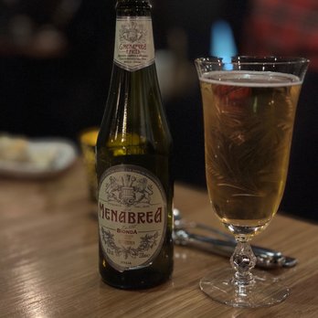 Olivia - a bottle of beer and a glass on a table - Italian Near Me - Denver, Colorado