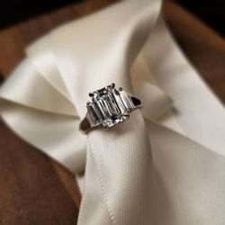 Austin's Fine Jewelry - 14K white gold engagement ring with 2.54ct emerald-cut diamond and baguette accents.