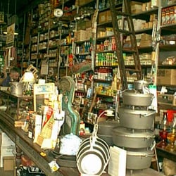 Rutledge Hardware - 100+ yr OLD Rutledge Hardware,  Rutledge Georgia with original Rolling ladders lining the walls along shelves floor to ceiling.