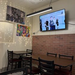 K Pop Foodz Korean Street Food - Indoor setting playing k-pop videos in TV