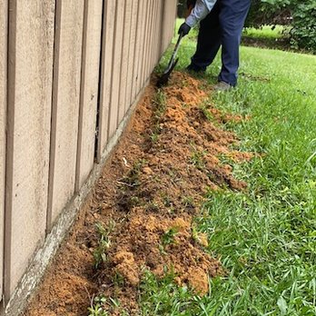 Master Exterminators - Another skilled technician trenching around the foundation of a building for a termite treatment! - Pest Control Near Me - Fayetteville, North Carolina