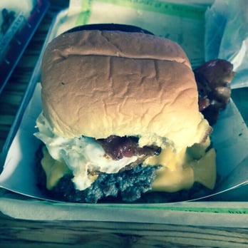 BurgerFi - Triple burger with grilled onions, American cheese, bacon, and an egg. - Burgers Near Me - Kennesaw, Georgia BurgerFi - Triple burger with grilled onions, American cheese, bacon, and an egg. - Burgers Near Me - Kennesaw, Georgia