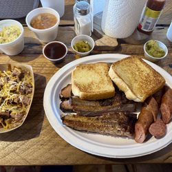 Best Of Texas Bar-B-Que - Three meat plate: sausage, brisket and rib. Sides: charro beans and potato salad. Also, Frito pie!