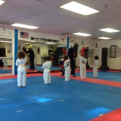 Harriday's Karate and Fitness - Mr. Harriday works with the kids on high blocks. Notice there is a senior student at every class.