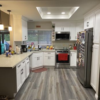 Panda Floor San Diego - a kitchen with white cabinets and stainless steel appliances - Flooring Near Me - San Diego, California Panda Floor San Diego - a kitchen with white cabinets and stainless steel appliances - Flooring Near Me - San Diego, California