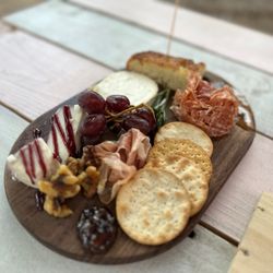 The Wine House - 2x2 charcuterie board. Red wine Gorgonzola, truffle (Gruyère?), prosciutto, hot sopresatta, and accoutrements