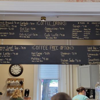 Griddle and Grind - Coffee choices and options on both signs. - Black chalkboard menu lists coffee drinks, syrups, alt milks, and free options like tea, cocoa, and soda at a café. - Creperies Near Me - Ephrata, Pennsylvania