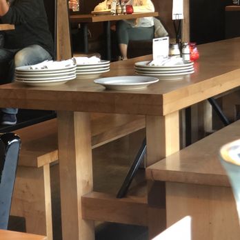 Zeeks Pizza - Extra plates and silverware stashed on the central table. - Pizza Near Me - Seattle, Washington Zeeks Pizza - Extra plates and silverware stashed on the central table. - Pizza Near Me - Seattle, Washington