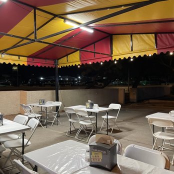 Taqueria Los Gavilanes - tables and chairs under a tent - Food Trucks Near Me Taqueria Los Gavilanes - tables and chairs under a tent - Food Trucks Near Me