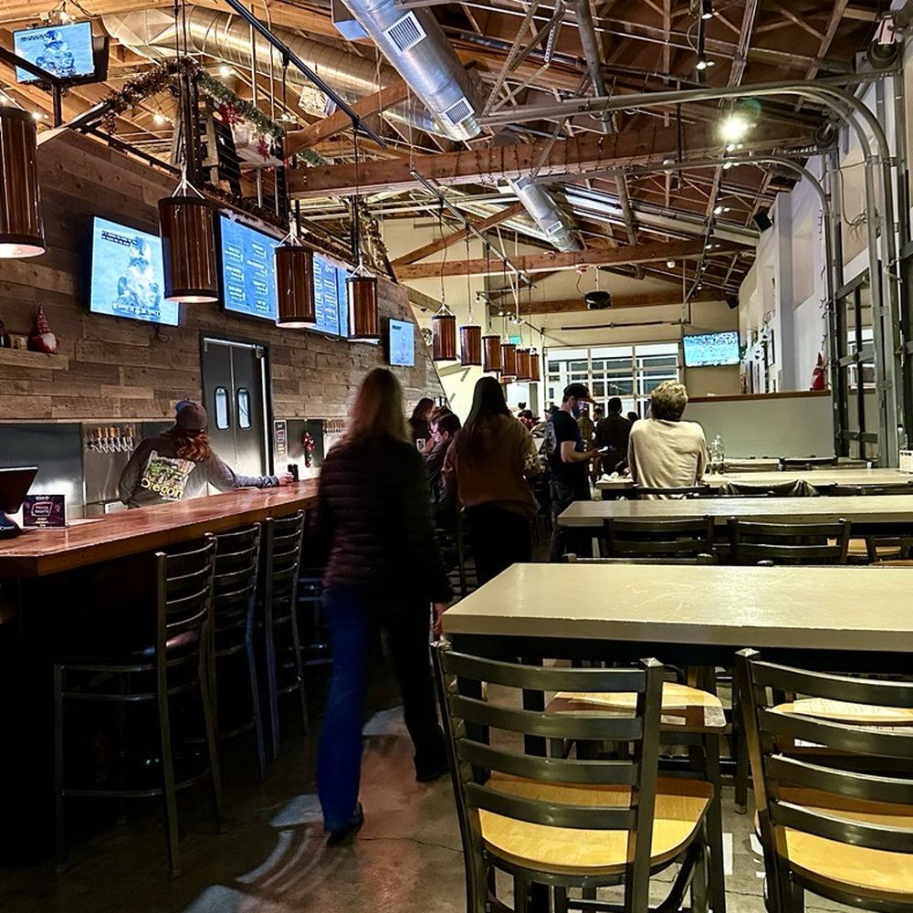 Crux Fermentation Project - Waking down the long aisle to our back table - bar on the left. - Brewpubs Near Me - Portland, Oregon
