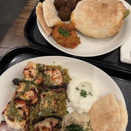 Chicken Kebab ($20.75) with freekeh, garlic dip, babaghanouge; Chicken Shawarma Pita ($19.25) with roasted red pepper dip and falalfels Chicken Kebab ($20.75) with freekeh, garlic dip, babaghanouge; Chicken Shawarma Pita ($19.25) with roasted red pepper dip and falalfels