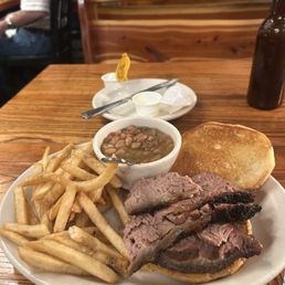 Sliced beef sandwich with fries and their spicy beans. Sliced beef sandwich with fries and their spicy beans.