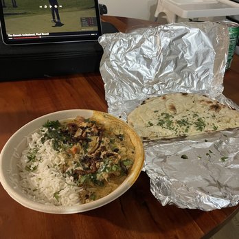 Makam's Indian Restaurant - Chicken and Lamb platter with Basmati Rice. In the background is the garlic naan. - Indian Near Me - Millcreek, Utah Makam's Indian Restaurant - Chicken and Lamb platter with Basmati Rice. In the background is the garlic naan. - Indian Near Me - Millcreek, Utah