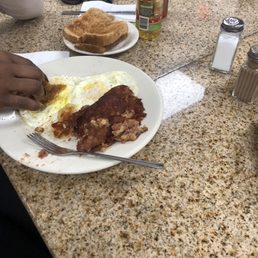 Corn beef hash with eggs over medium wheat toast very good