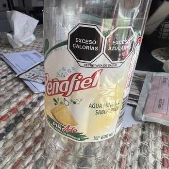 Carnitas Chepa - a bottle of water on a table - Grocery Near Me - West Chicago, Illinois
