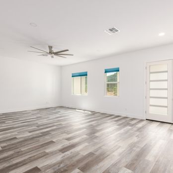 Property Pros Improvements - empty living room with hardwood floors - Painters Near Me Property Pros Improvements - empty living room with hardwood floors - Painters Near Me