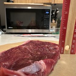 Bryan’s Meat Company - Less then 1/2". Way to ruin a New York steak.