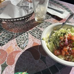 Tostada in bowl with cheese on side Tostada in bowl with cheese on side