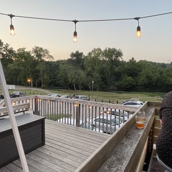 Oversoul Brewing - a man sitting on a deck overlooking a parking lot - Breweries Near Me - Helena, Alabama Oversoul Brewing - a man sitting on a deck overlooking a parking lot - Breweries Near Me - Helena, Alabama