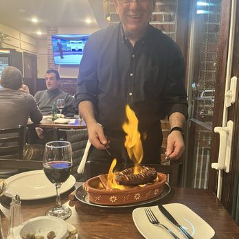 O Pipo Tavern - Antonio serving the flaming roasted sausages - Portuguese Near Me - Newark, New Jersey O Pipo Tavern - Antonio serving the flaming roasted sausages - Portuguese Near Me - Newark, New Jersey