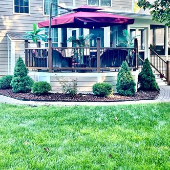 123 Steps - a patio with a table and umbrella - General Contractors Near Me - Indianapolis, Indiana