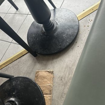 Supreme Dumplings - Dirty table bases, bits of food on floor, old cardboard used as table wedge. - Shanghainese Near Me - Kirkland, Washington Supreme Dumplings - Dirty table bases, bits of food on floor, old cardboard used as table wedge. - Shanghainese Near Me - Kirkland, Washington