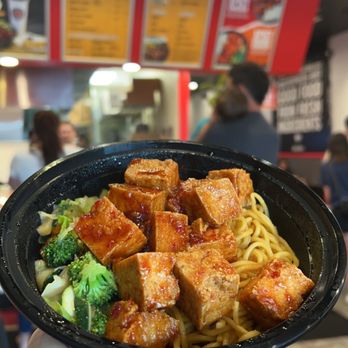 Teriyaki Madness - a person holding a plate of food - Japanese Near Me - Lombard, Illinois