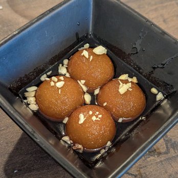 Delhi Darling - Gulab Jamun - milk doughnuts - are so fluffy and sweet, with an aroma of cardamon and rosewater - Bars Near Me - Hampstead, North Carolina Delhi Darling - Gulab Jamun - milk doughnuts - are so fluffy and sweet, with an aroma of cardamon and rosewater - Bars Near Me - Hampstead, North Carolina