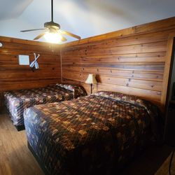 Aurora's Kentucky Lake Cottages - Motel 2 offers a comfortable stay with two cozy queen beds. The room is equipped with a mini fridge, microwave, and coffee pot.