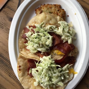 Explorers Club - Breakfast tacos with fried egg and bacon, topped with jalapeño slaw and a potato cake in the side. - Latin American Near Me - Columbus, Ohio