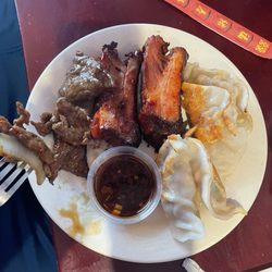 Hibachi Grill Supreme Buffet - My boyfriends plate of dumplings, ribs, and beef
