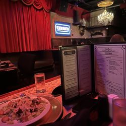 Teatro Martini - Caesar salad and menu with stage in the background