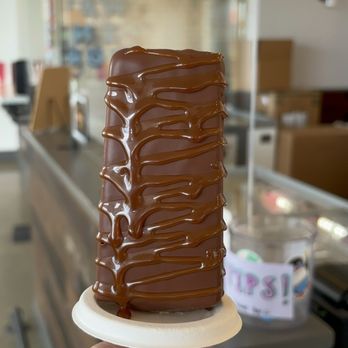 Seattle Pops - a hand holding a chocolate cake - Desserts Near Me - Seattle, Washington