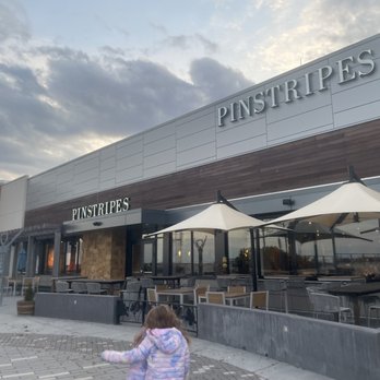 Pinstripes - a little girl walking in front of a restaurant - New American Near Me - Norwalk, Connecticut