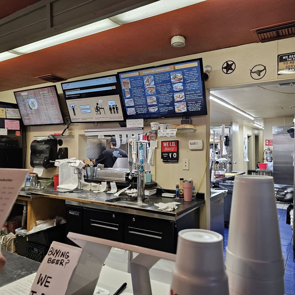 Rebel BBQ - a man ordering food at the counter - Barbeque Near Me - Blythe, California Rebel BBQ - a man ordering food at the counter - Barbeque Near Me - Blythe, California