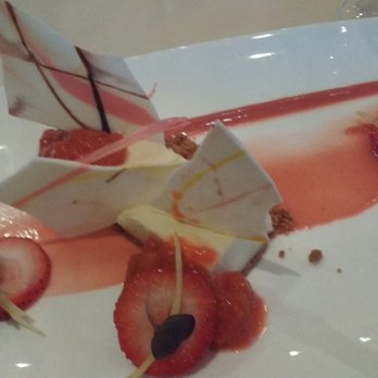 Cafe Nuovo - Lemon cheesecake with rhubarb compote, strawberry slices and candied lemon peel. - New American Near Me - Providence, Rhode Island