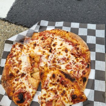 Pelican Pete’s Mobile Pizza - a slice taken out of it - Pizza Near Me Pelican Pete’s Mobile Pizza - a slice taken out of it - Pizza Near Me
