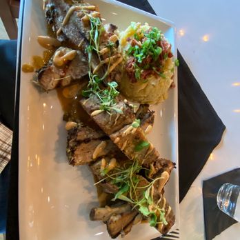 Crave Kitchen & Bar - Braised ribs with a creamer sauce, with mashed potatoes, topped with bacon. YUM! - Bars Near Me - Eagle, Idaho Crave Kitchen & Bar - Braised ribs with a creamer sauce, with mashed potatoes, topped with bacon. YUM! - Bars Near Me - Eagle, Idaho