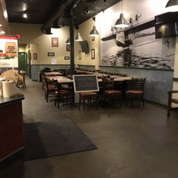 the inside of a restaurant with tables and chairs