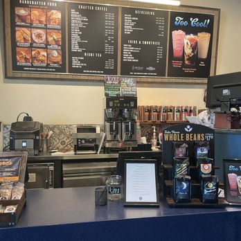 Satellite Coffee - Coffee shop counter with menu boards displaying handcrafted food, crafted coffee, refreshing drinks, and smoothies. Equipment includes a coffee machine, tips jar, and display racks. - Coffee & Tea Near Me - Albuquerque, New Mexico