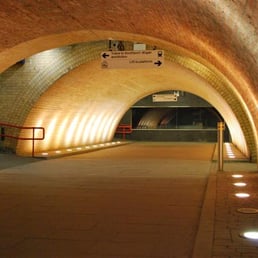 Architecturally-impressive but almost eerily quiet tunnel towards the station platforms.