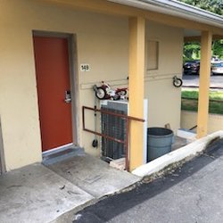Budget Inn Falls Church - The outside of my room. That's right, a busted tricycle and refrigerator sitting outside my door. Not like their pics